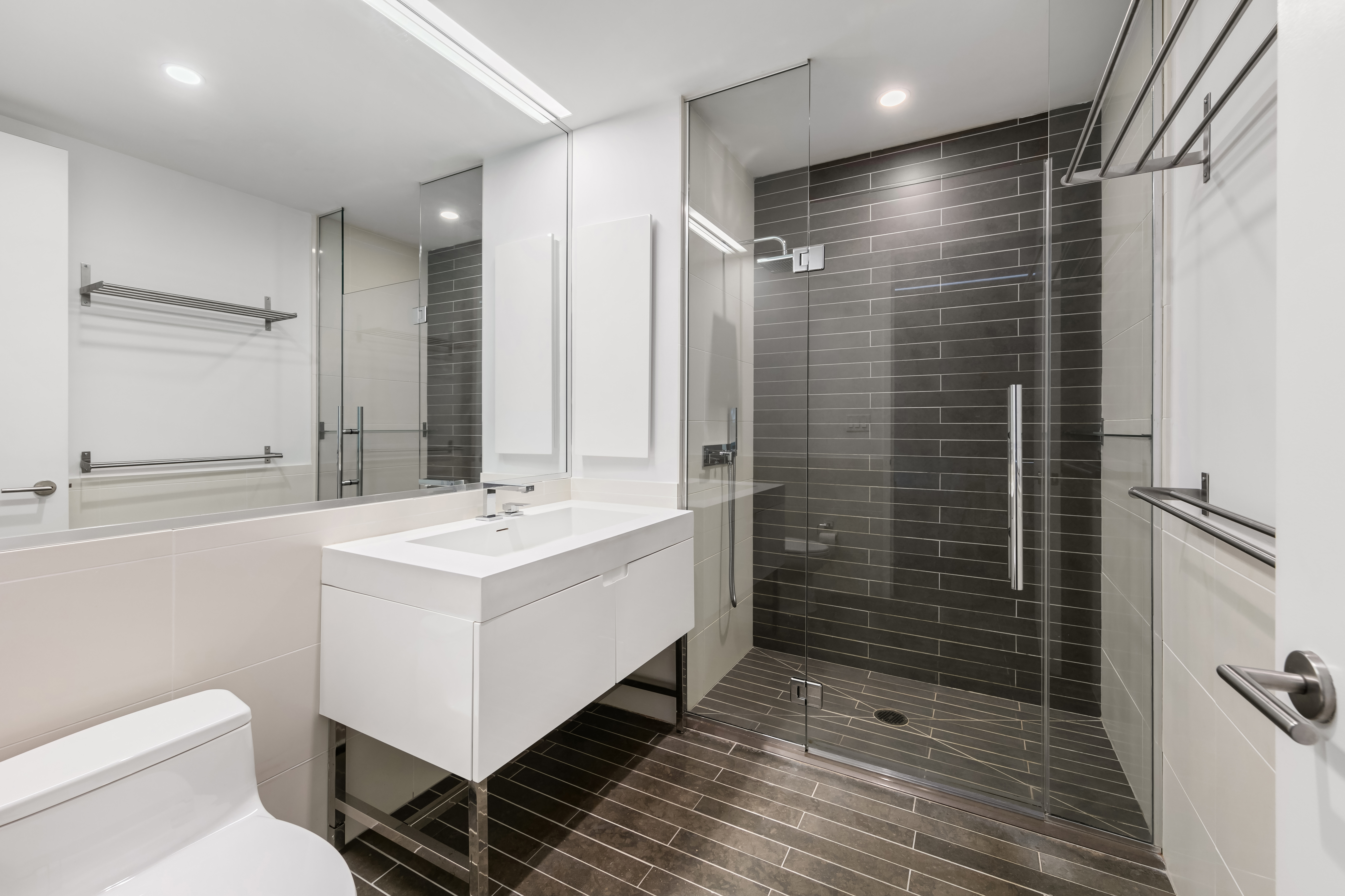 388 Bridge Street, Unit PH47A Brooklyn, NY 11201 - Photo 8 of 12 a bathroom with a sink a toilet and shower