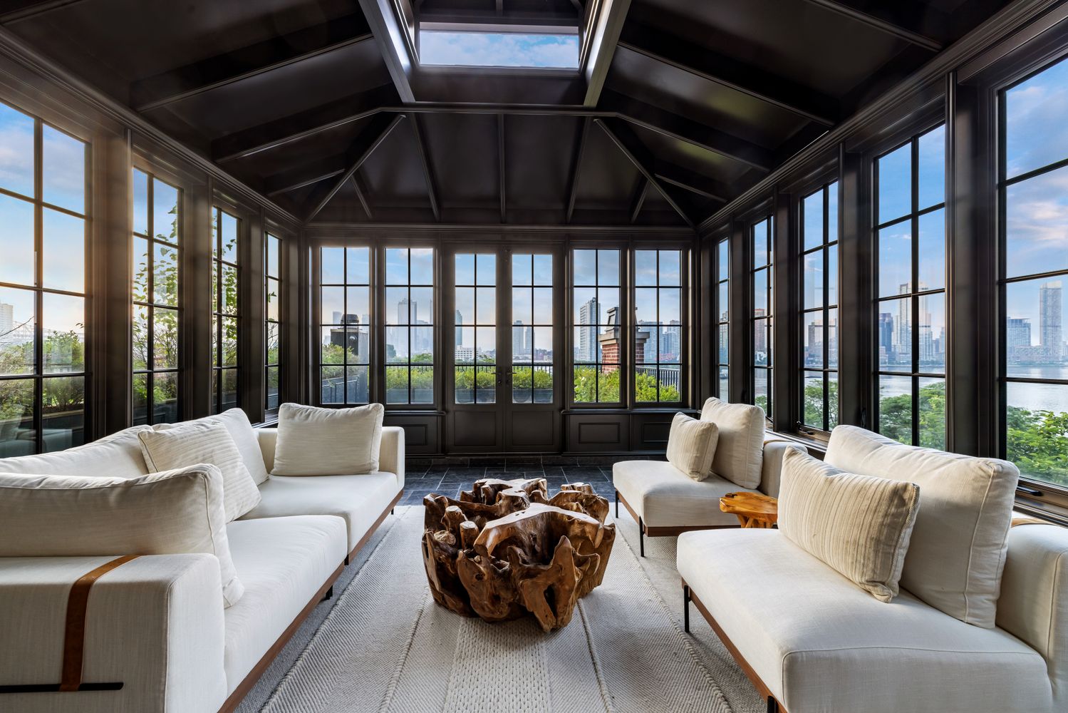 a living room with furniture and a floor to ceiling window
