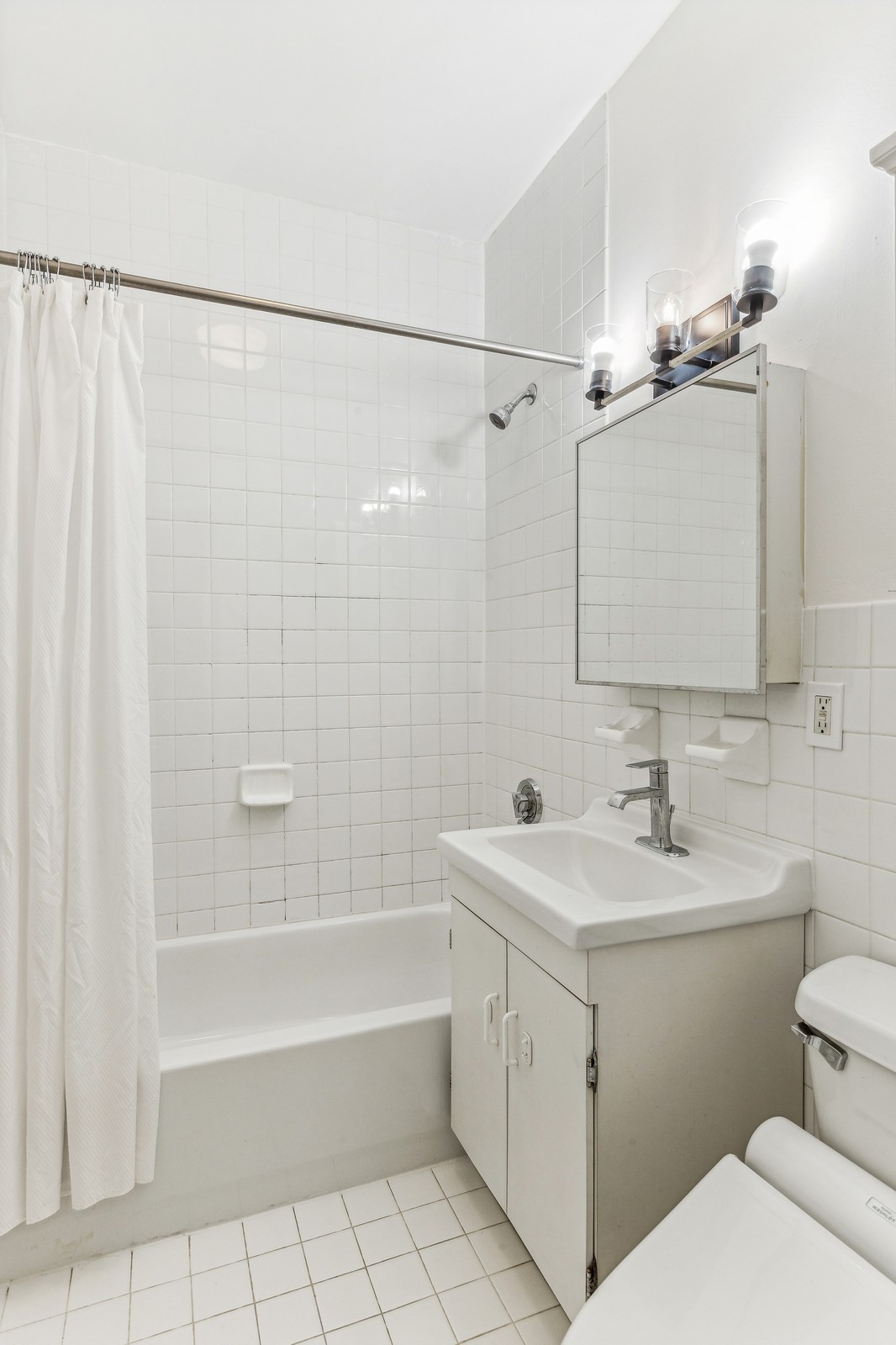 307 West 111th Street, Unit 2R Manhattan, NY 10026 - Photo 5 of 16 a bathroom with a sink a toilet and shower