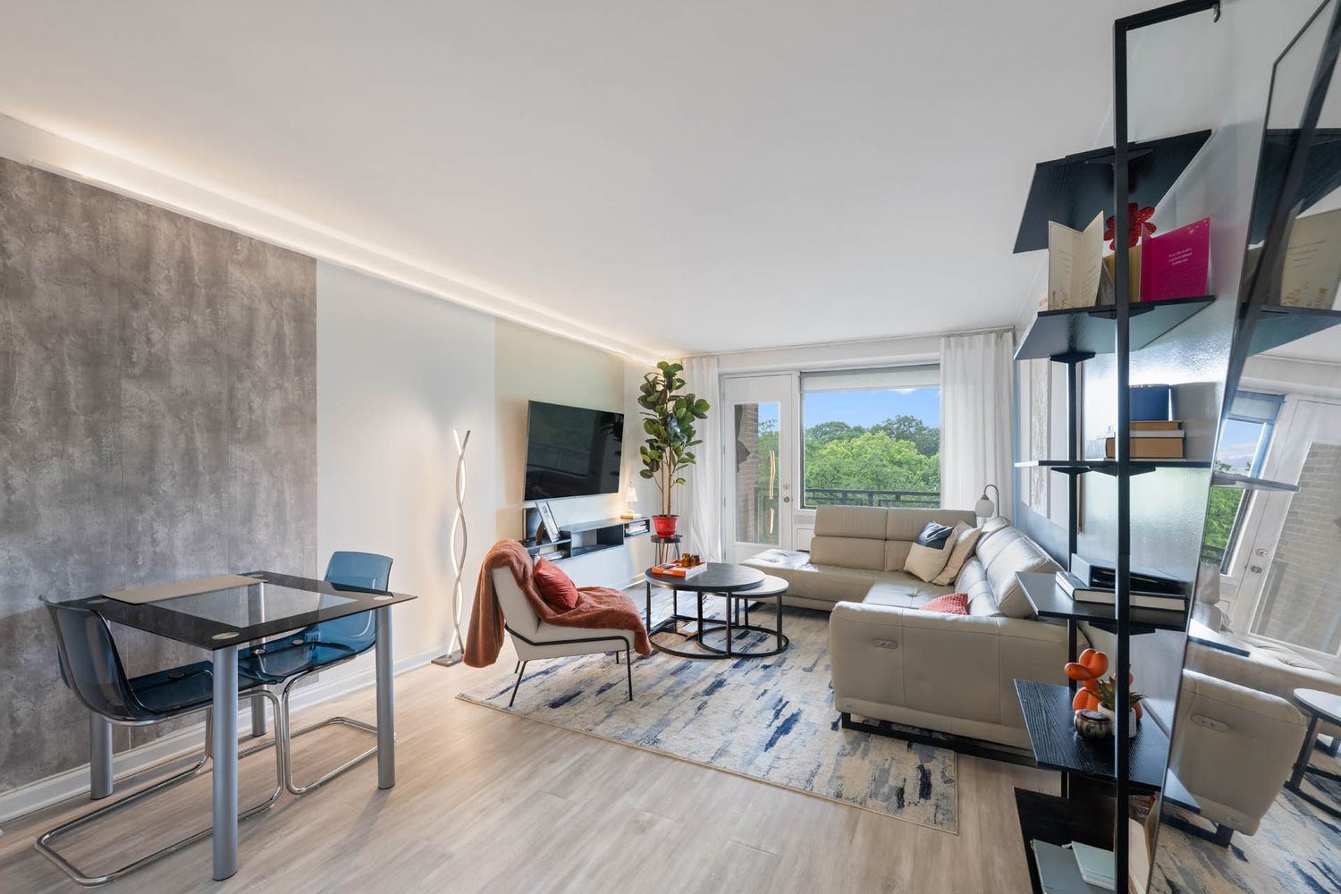 a living room with furniture fireplace and a large window
