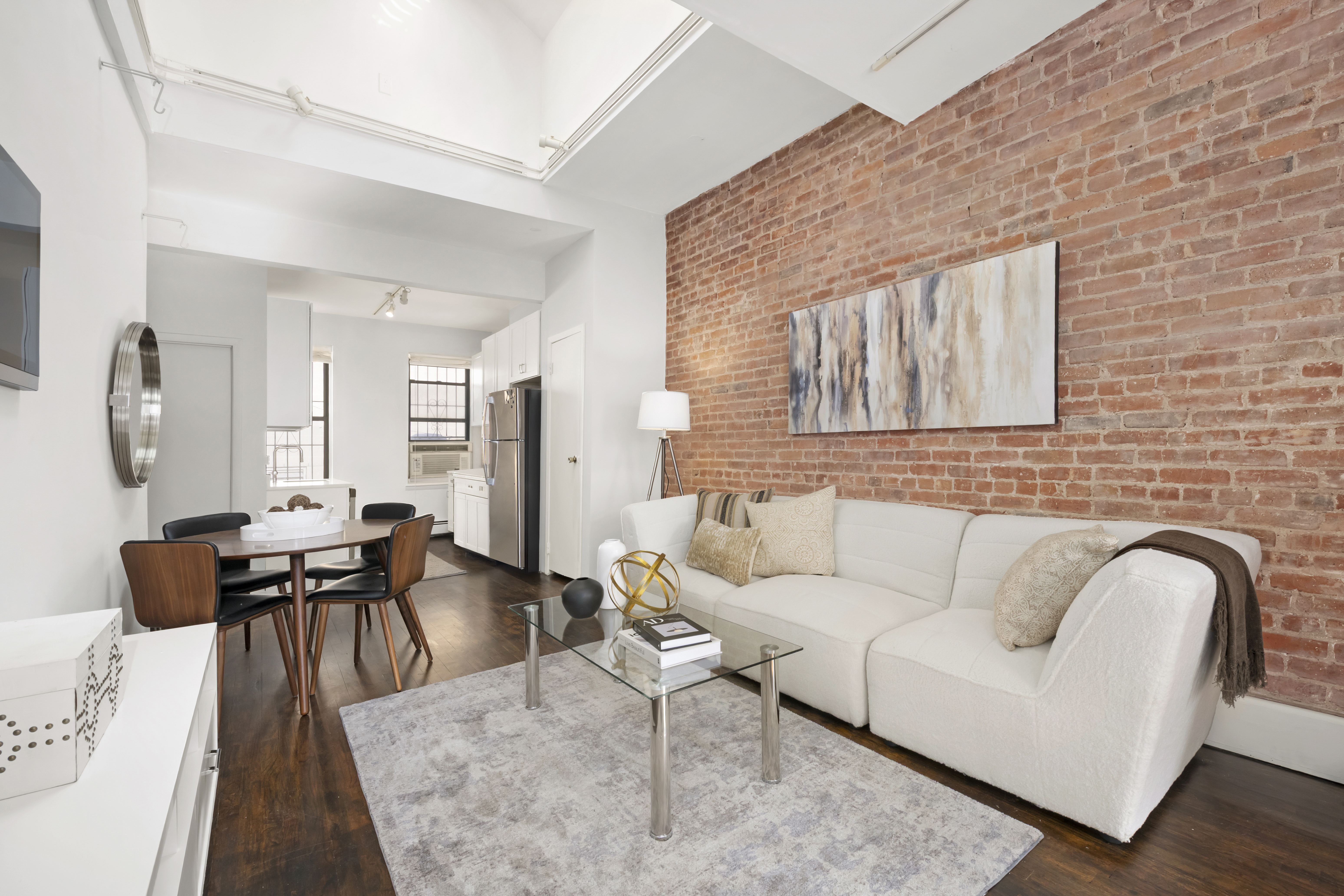 351 West 53rd Street, Unit 4E Manhattan, NY 10019 - Photo 3 of 9 a living room with furniture and wooden floor