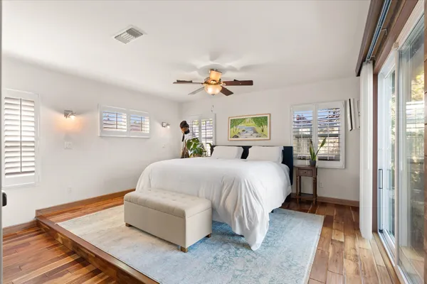 a bedroom with a bed and a chandelier