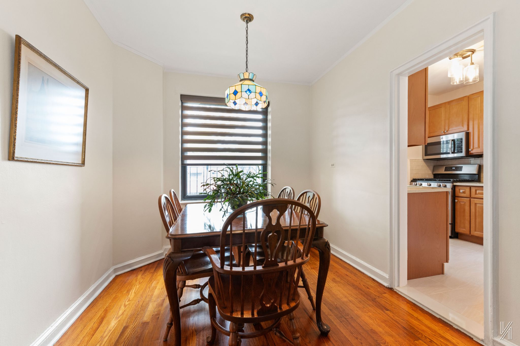 22-08 76th Street, Unit D2 Queens, NY 11370 - Photo 9 of 20 a view of a dining room with furniture window and wooden floor