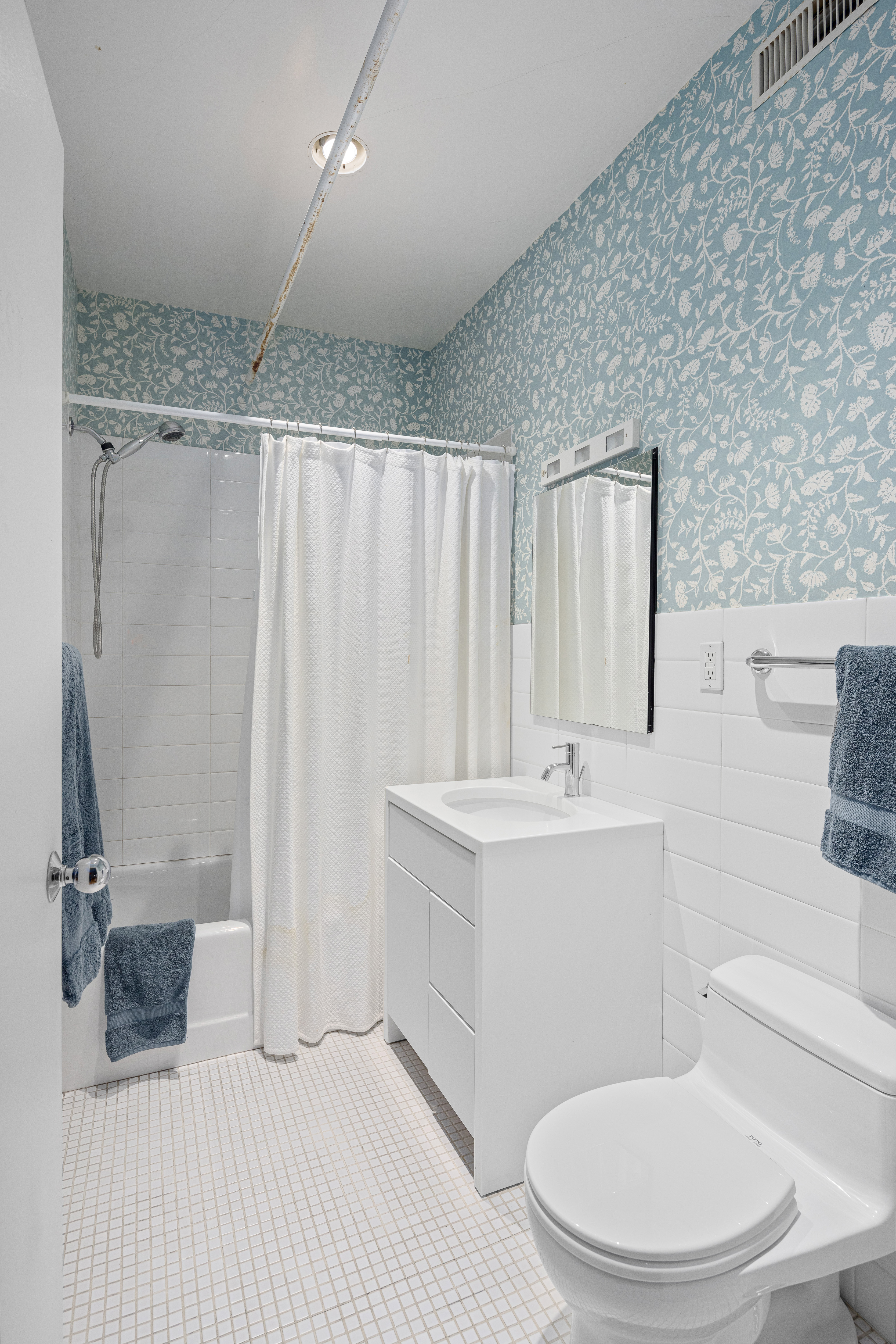 191 Chrystie Street, Unit 5R Manhattan, NY 10002 - Photo 14 of 16 a bathroom with a sink a toilet and shower