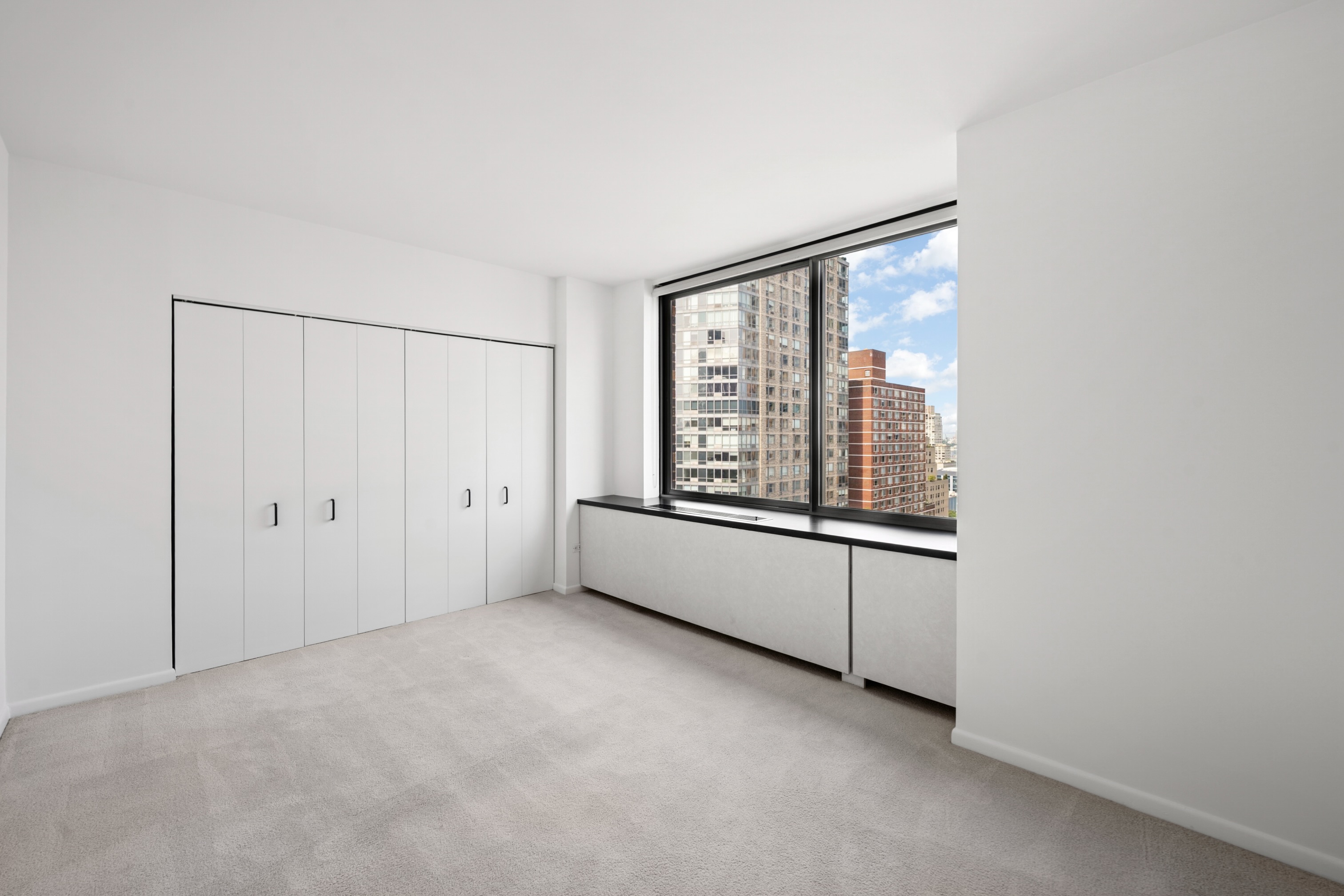 111 West 67th Street, Unit 22B Manhattan, NY 10023 - Photo 6 of 10 an empty room with windows