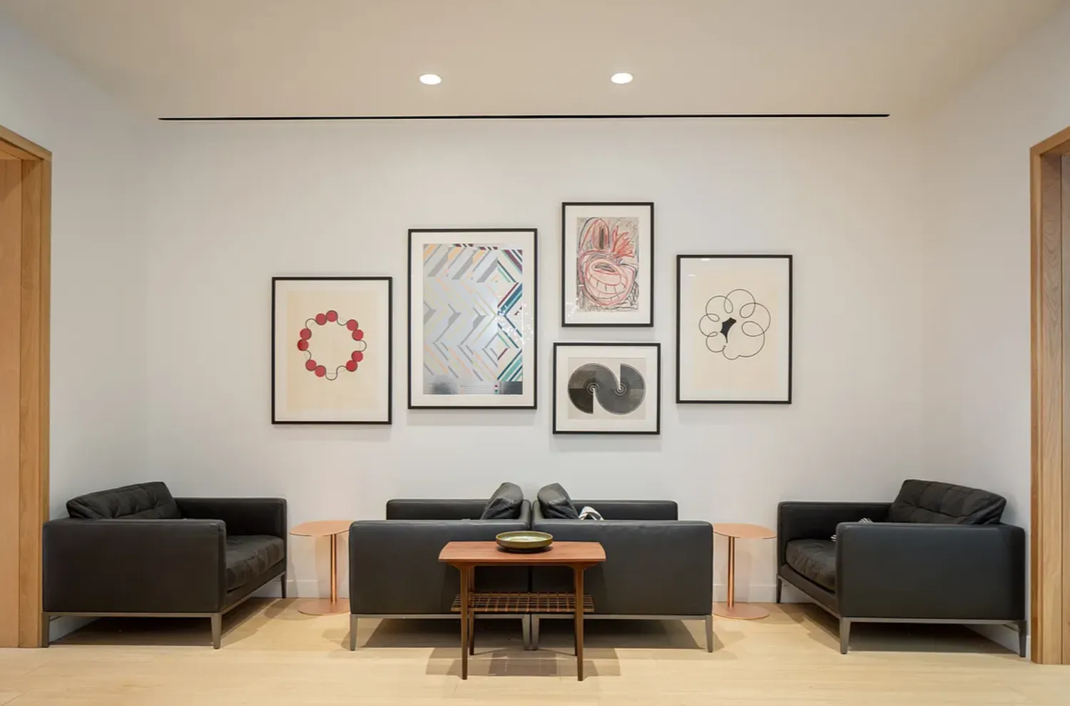 a living room with furniture and wall paintings