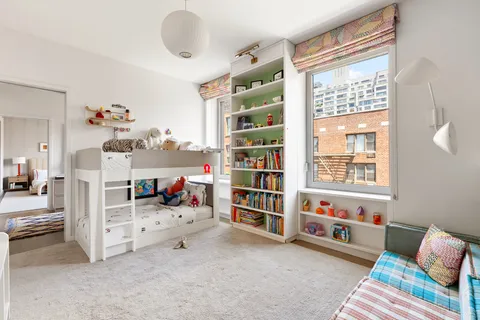 a bedroom with furniture and a book shelf