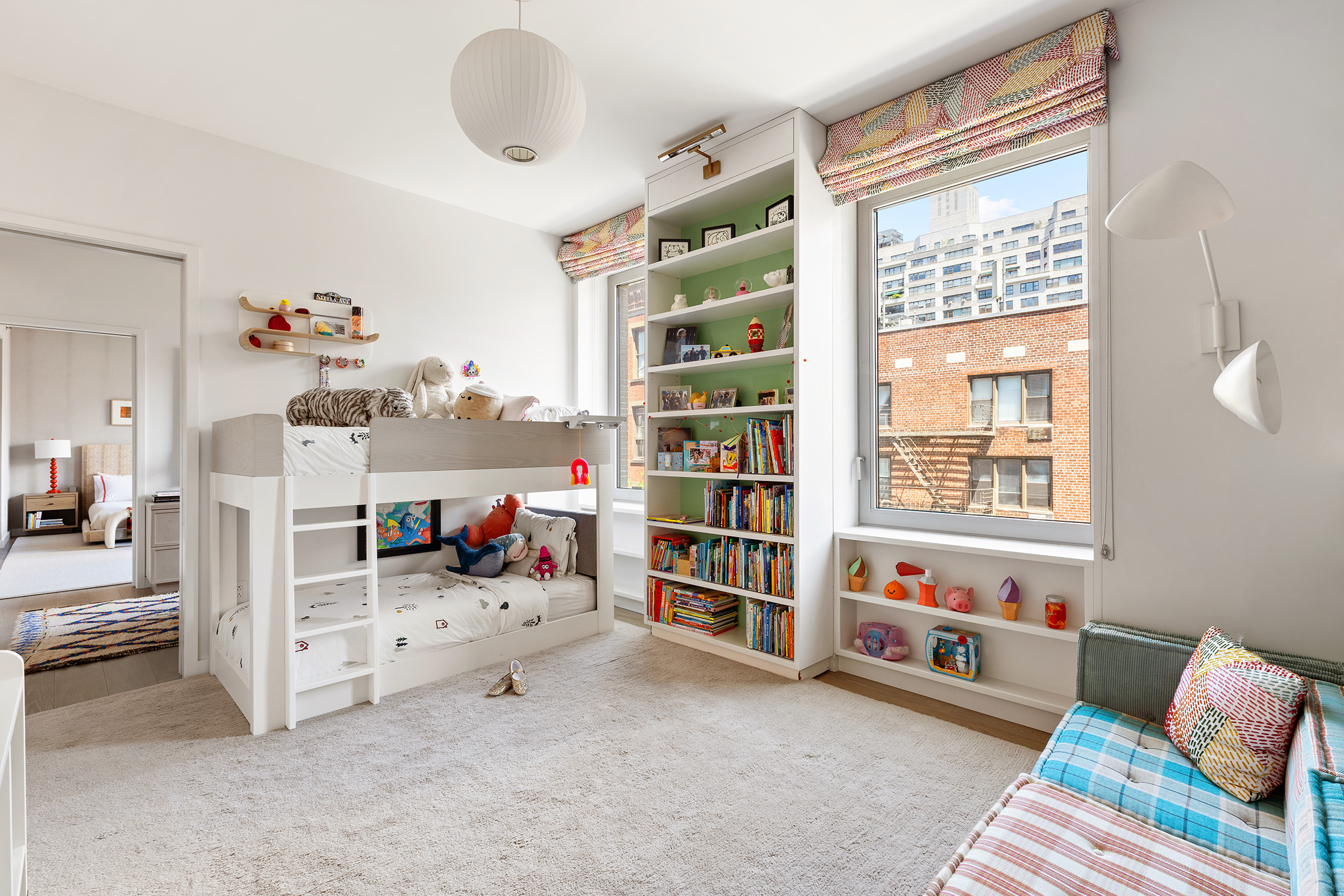 116 University Place, Unit 5 Manhattan, NY 10003 - Photo 14 of 19 a bedroom with furniture and a book shelf
