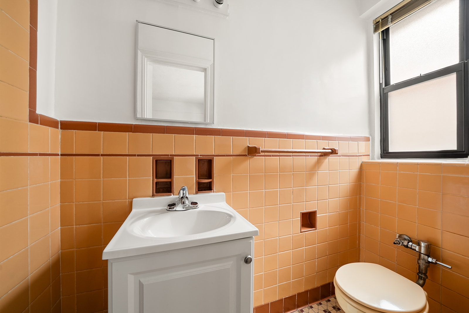 35-30 73rd Street, Unit 1F Queens, NY 11372 - Photo 8 of 10 a bathroom with a sink a toilet and a mirror