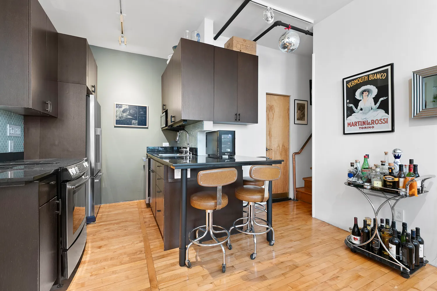 a kitchen with stainless steel appliances kitchen island granite countertop a refrigerator and a stove top oven