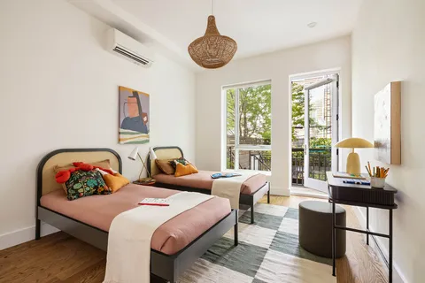 a bedroom with furniture and a large window