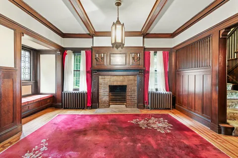 a living room with furniture large window and a fireplace