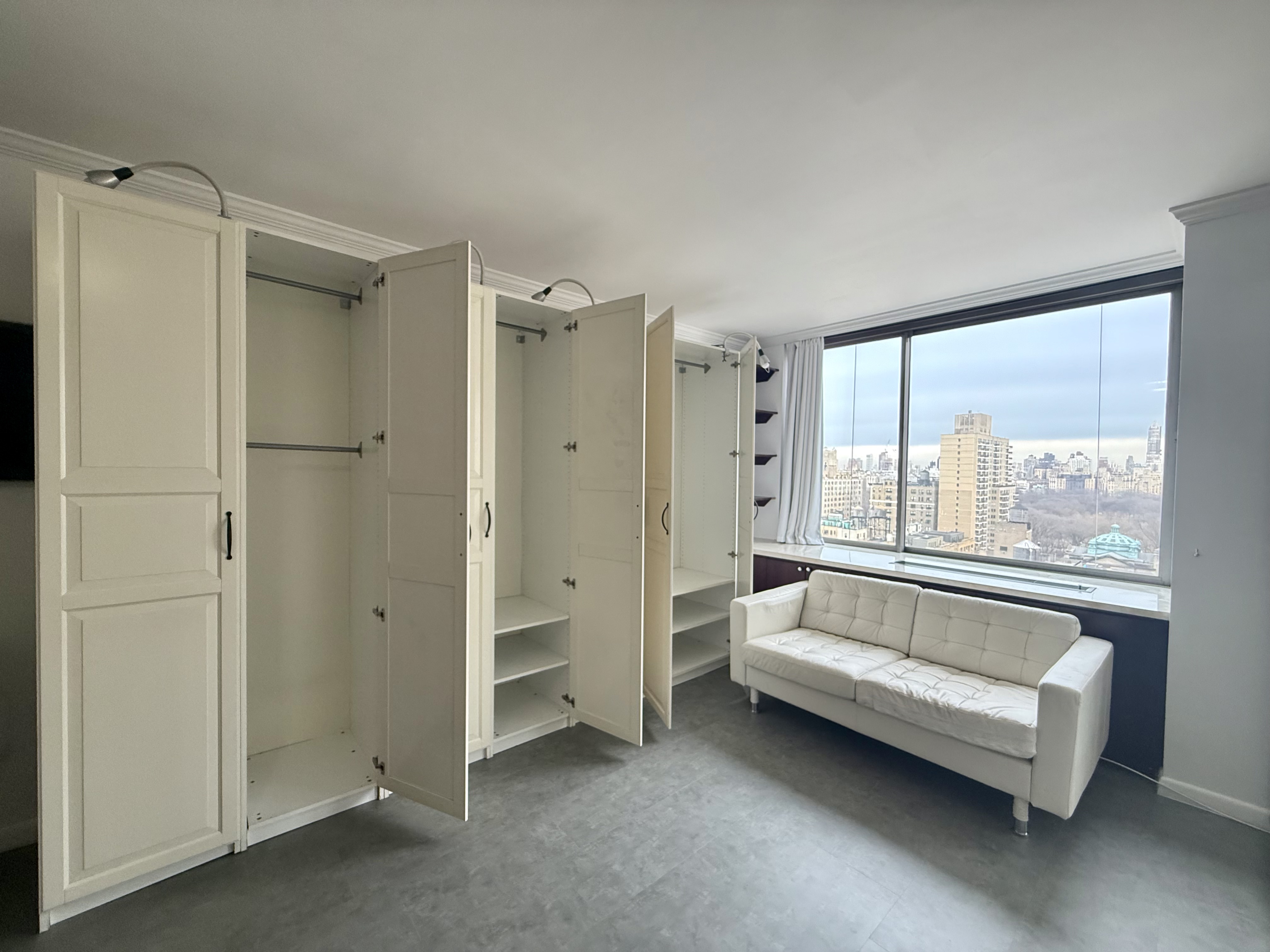 111 West 67th Street, Unit 22K Manhattan, NY 10023 - Photo 5 of 14 a spacious bedroom with a bed and a large window