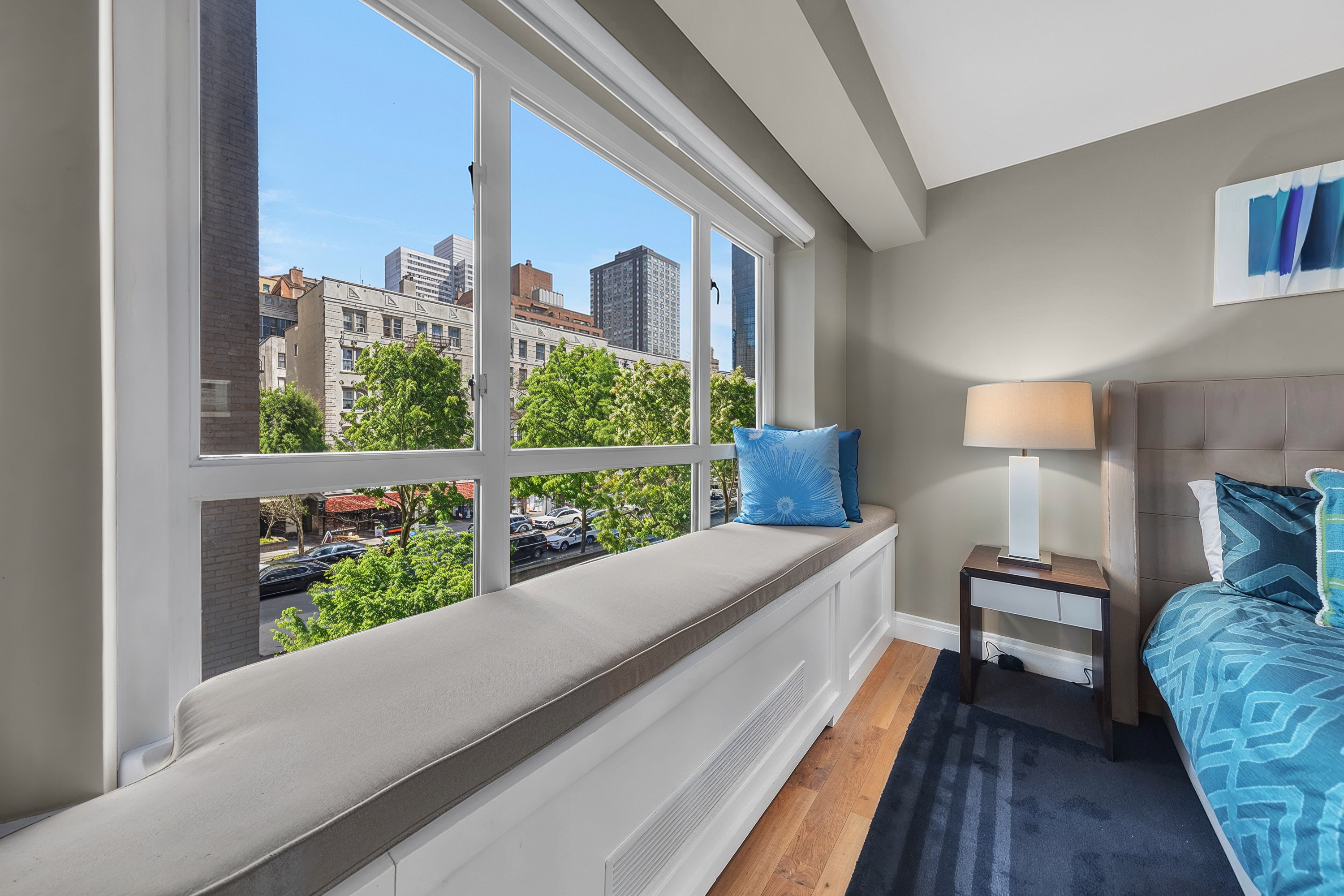 200 East 66th Street, Unit A407 Manhattan, NY 10065 - Photo 8 of 24 a room with a bed and a large window