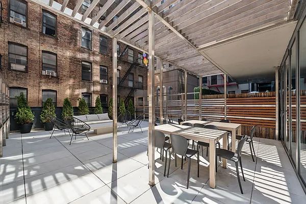 a view of a patio with table and chairs and potted plants