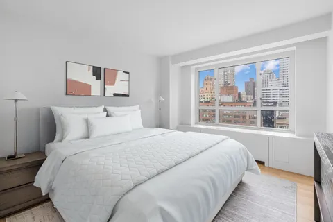 a bedroom with a large bed and a window