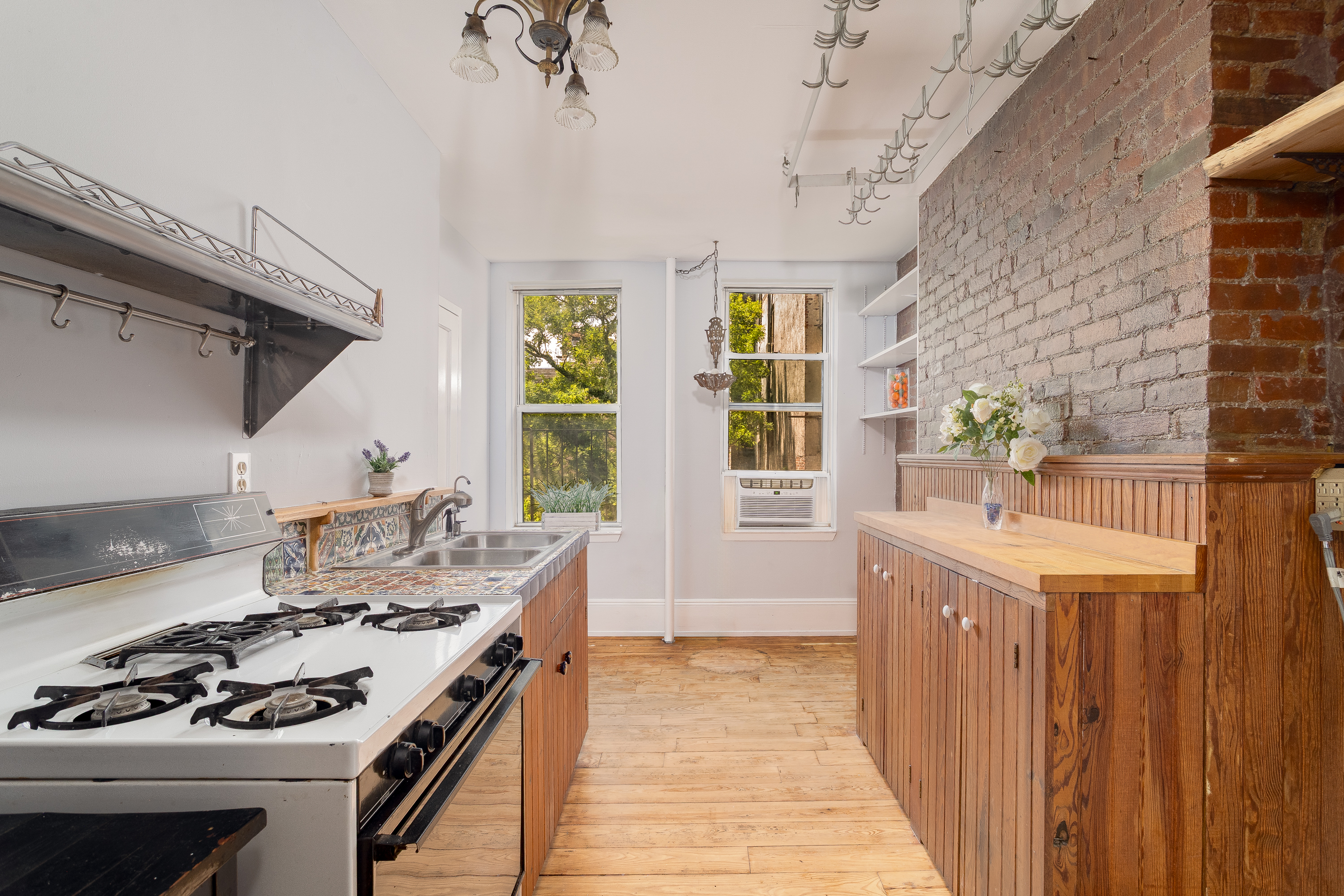 616 East 9th Street, Unit 4W Manhattan, NY 10009 - Photo 7 of 20 a kitchen that has a sink and a stove