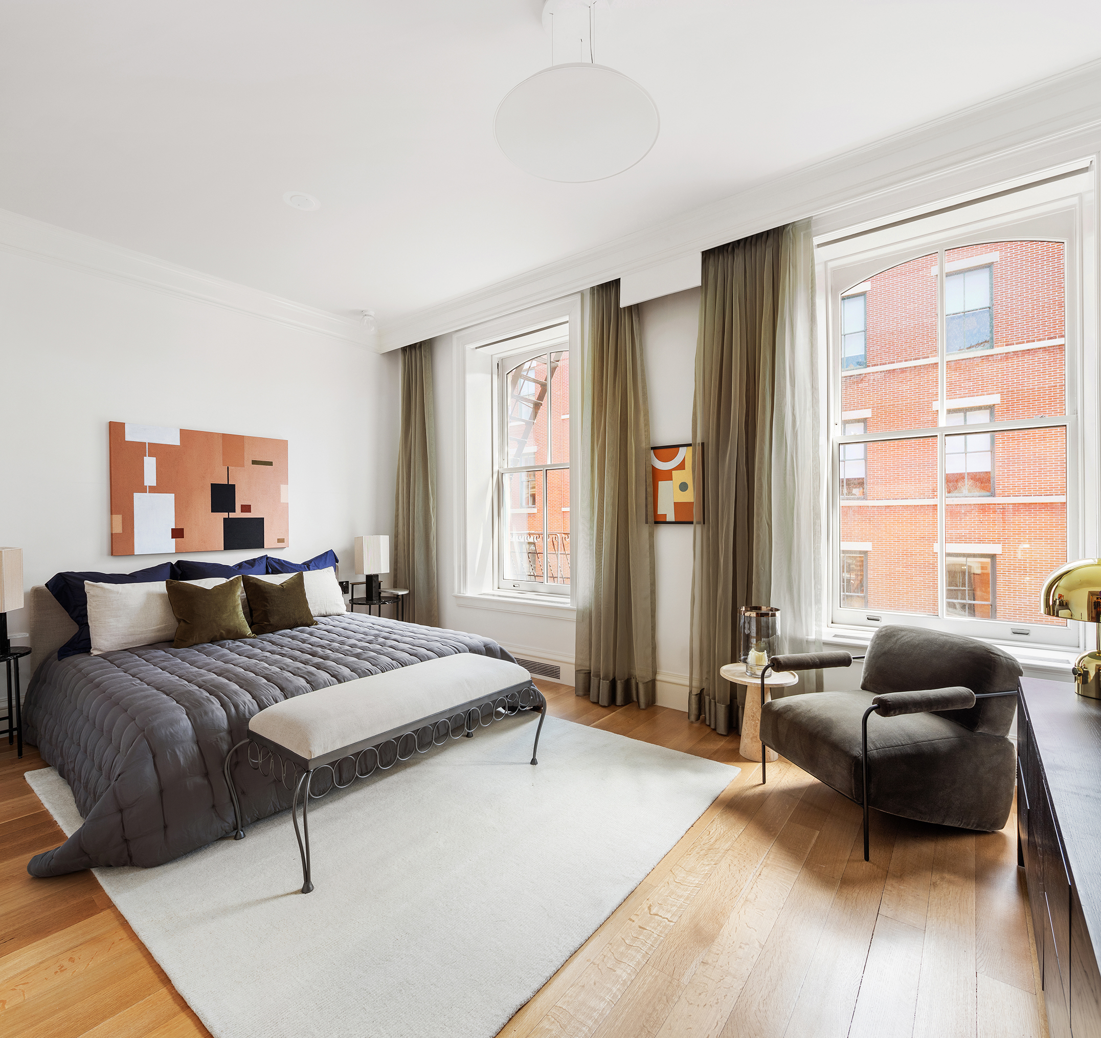 470 Broome Street, Unit 4S Manhattan, NY 10013 - Photo 10 of 14 a bedroom with a bed a couch and a dresser next to a window