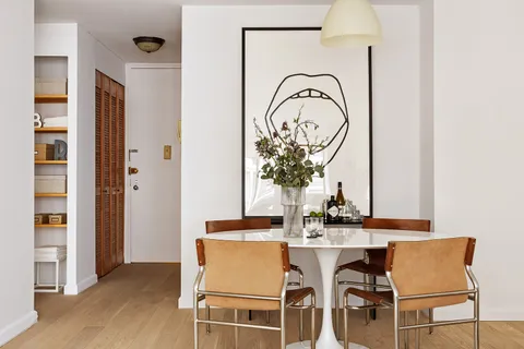 a dining room with furniture and wooden floor