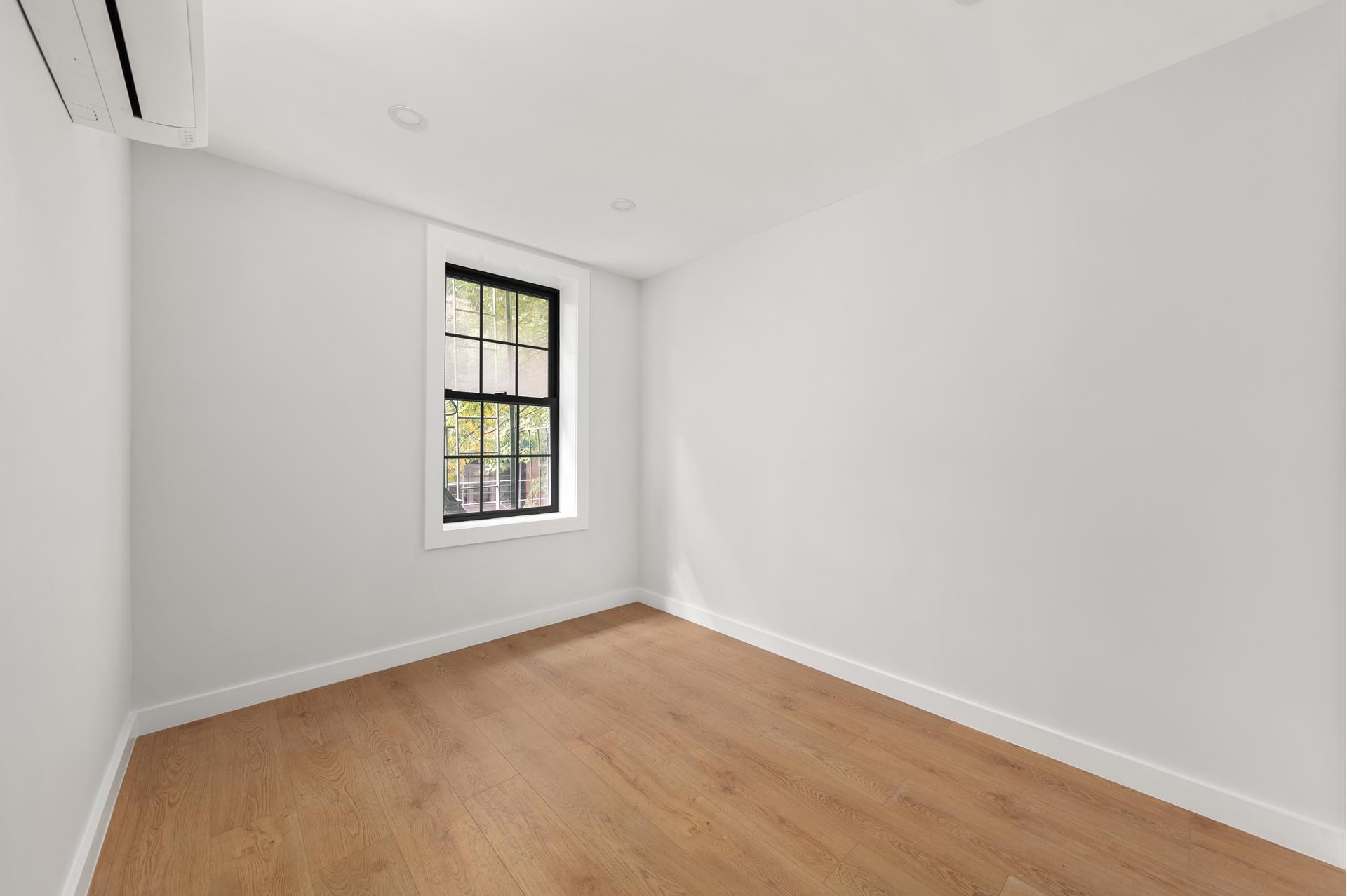 227 East 21st Street, Unit 2F Manhattan, NY 10010 - Photo 4 of 7 an empty room with a window