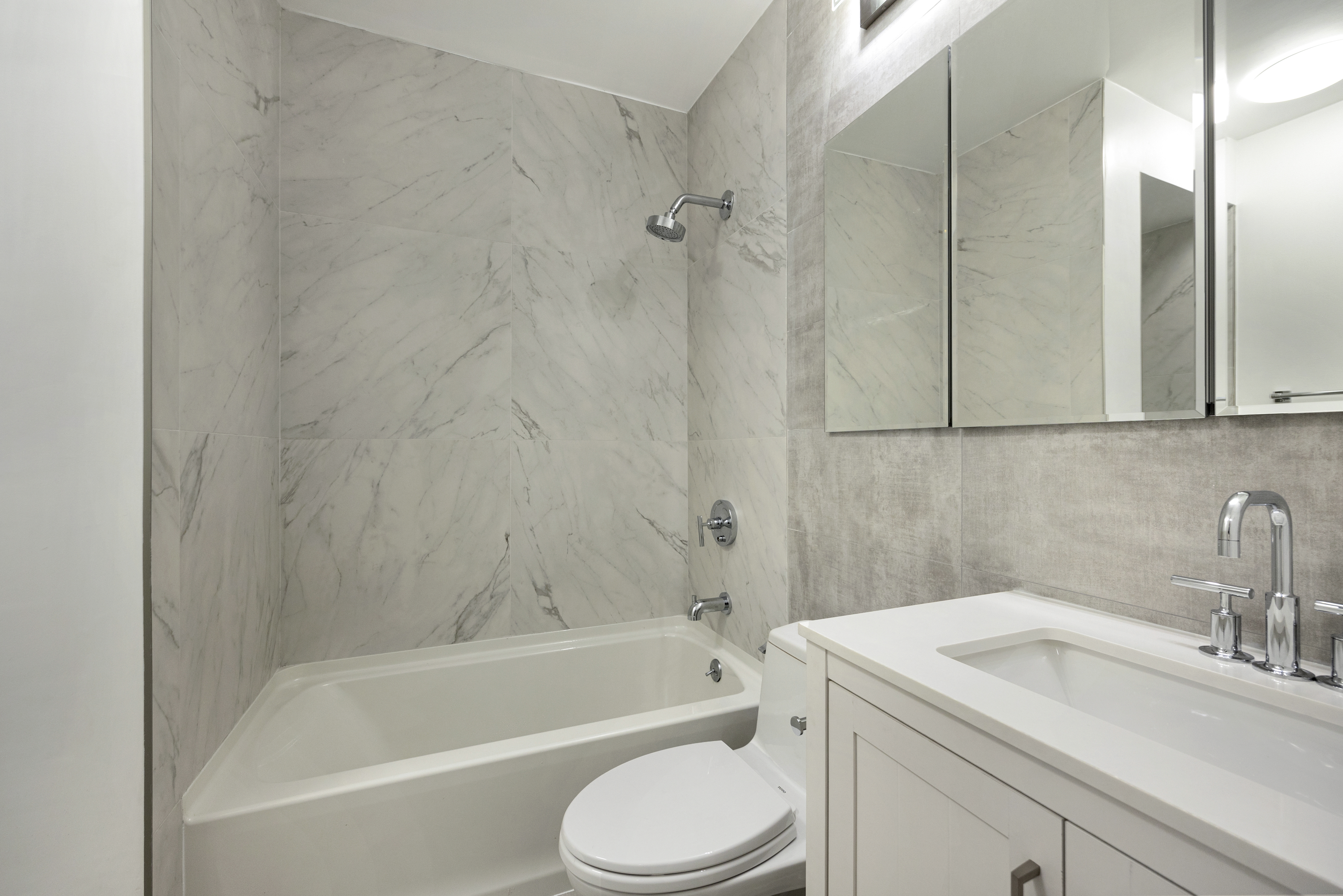 62 West 62nd Street, Unit 18A Manhattan, NY 10023 - Photo 11 of 16 a bathroom with a sink toilet and bathtub