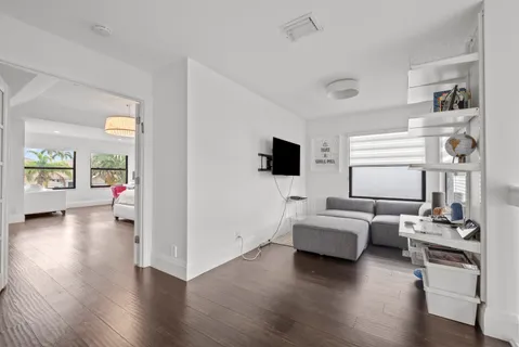 a dining room with furniture wooden floor a rug and a painting