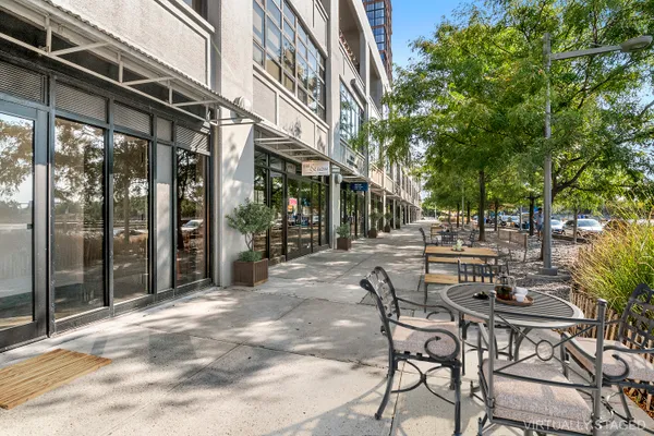 a view of a patio with table and chairs and potted plants