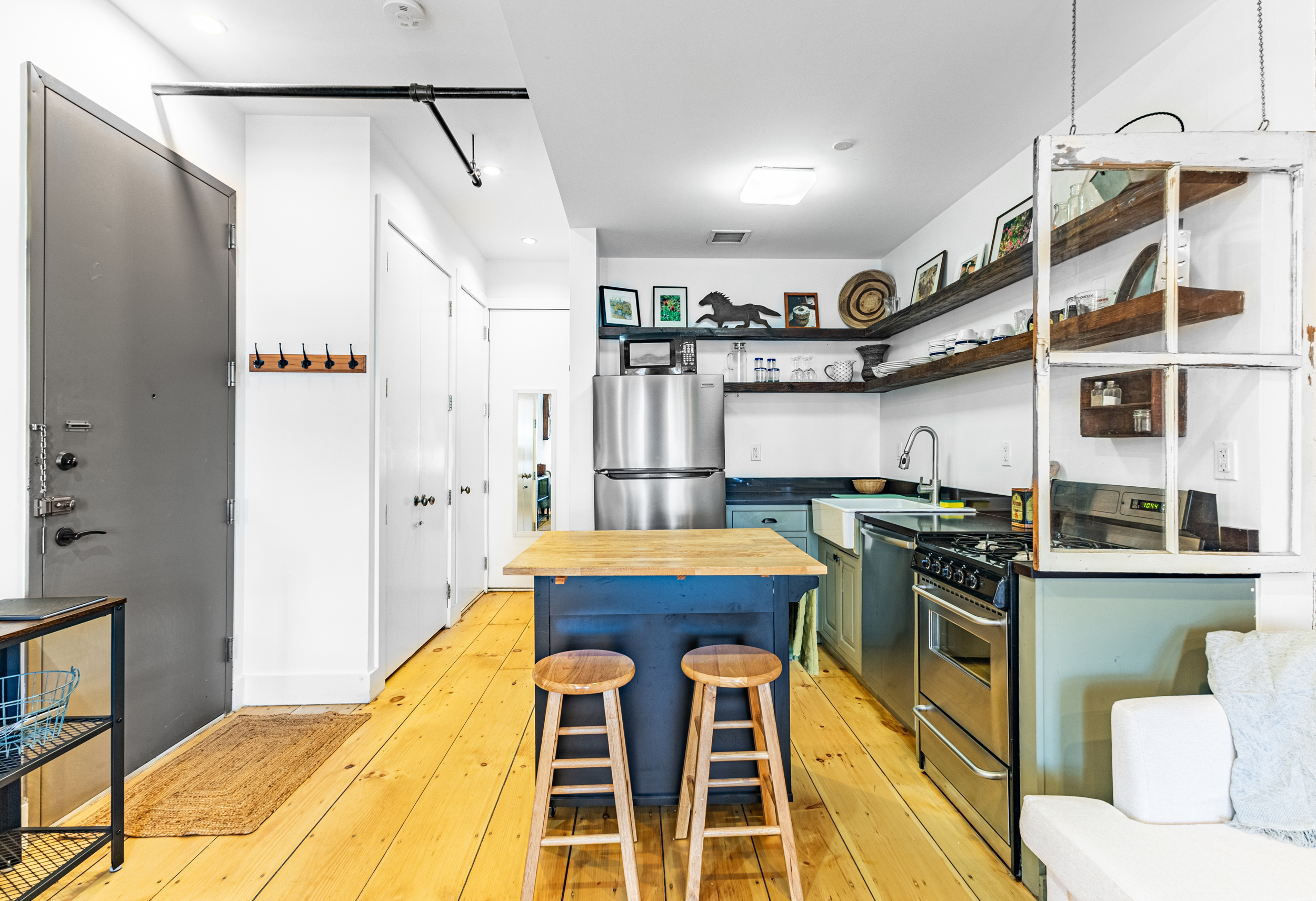 940 Fulton Street, Unit 3B Brooklyn, NY 11238 - Photo 5 of 18 a kitchen that has a lot of white cabinets and stainless steel appliances