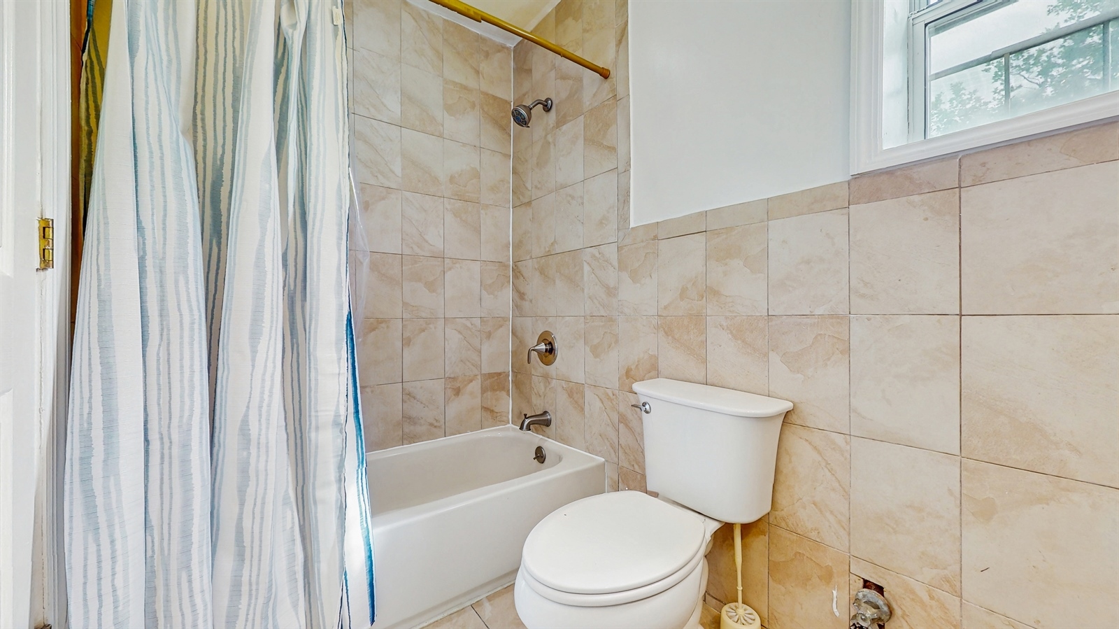 295 Conklin Avenue, Unit 3 Brooklyn, NY 11236 - Photo 14 of 15 a white toilet sitting next to a bath tub