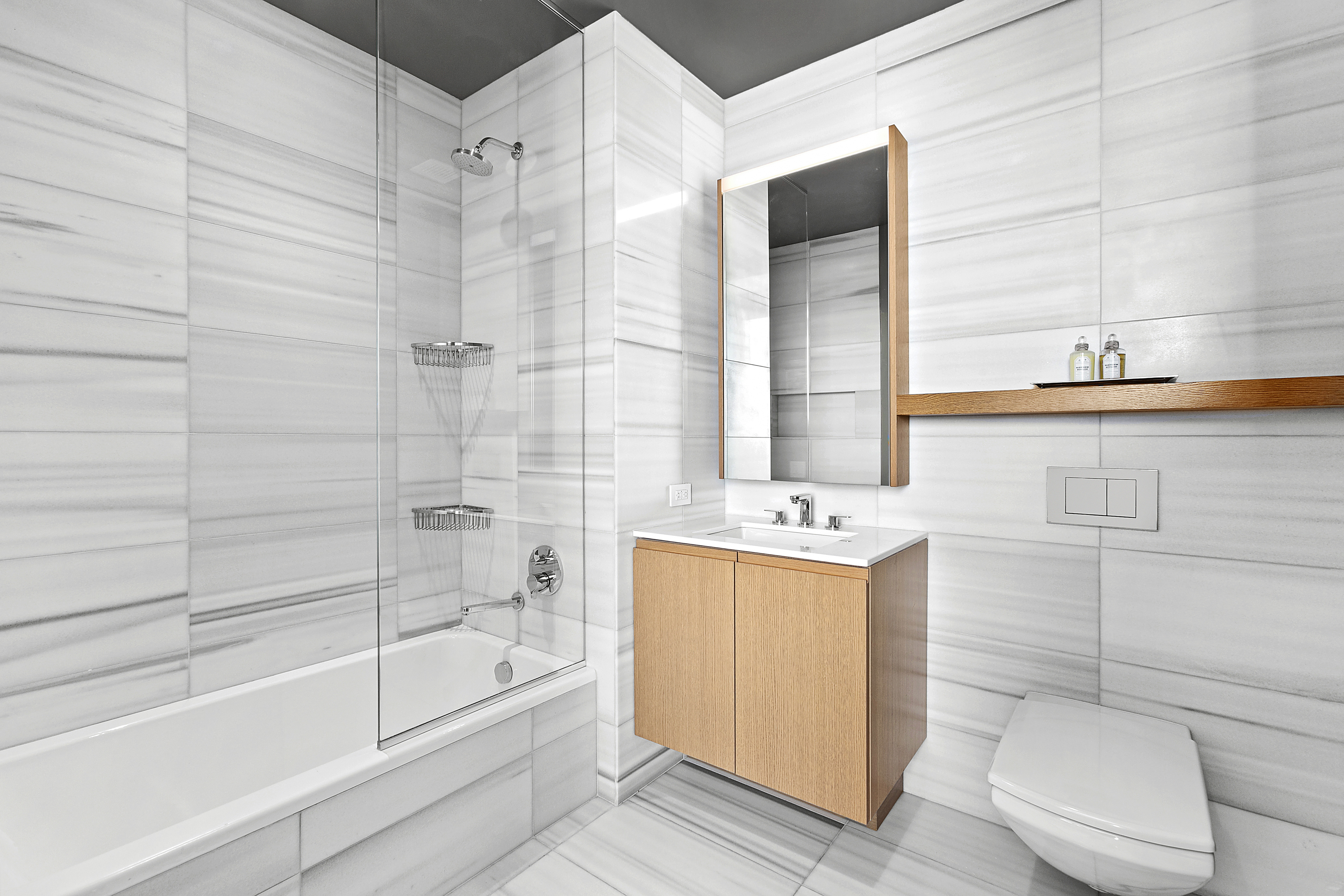 50 West Street, Unit 45B Manhattan, NY 10006 - Photo 7 of 8 a bathroom with a sink a toilet and bathtub