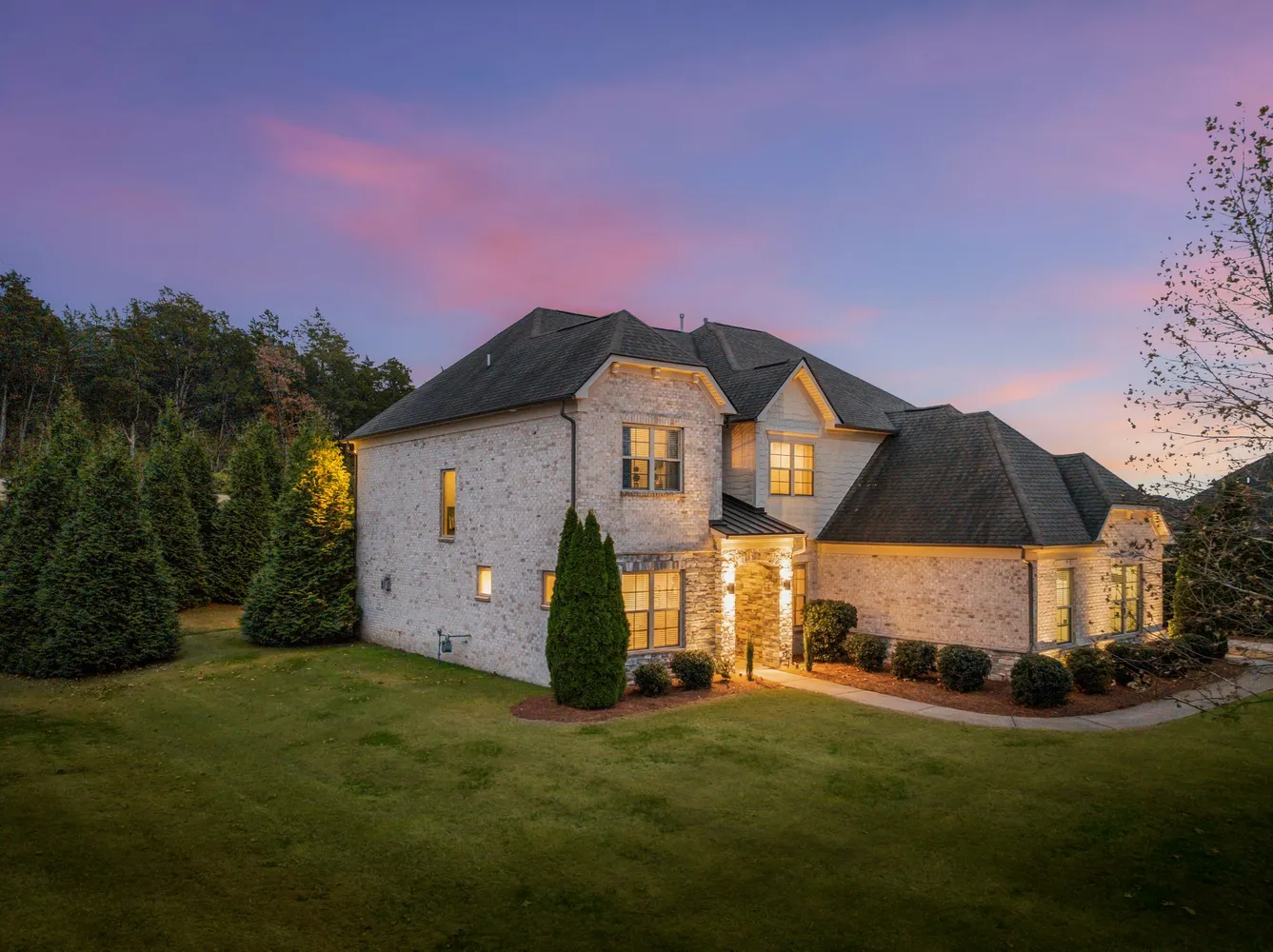 a front view of a house with a garden
