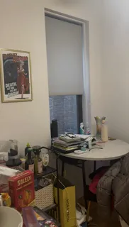 a dining room with furniture and a mirror