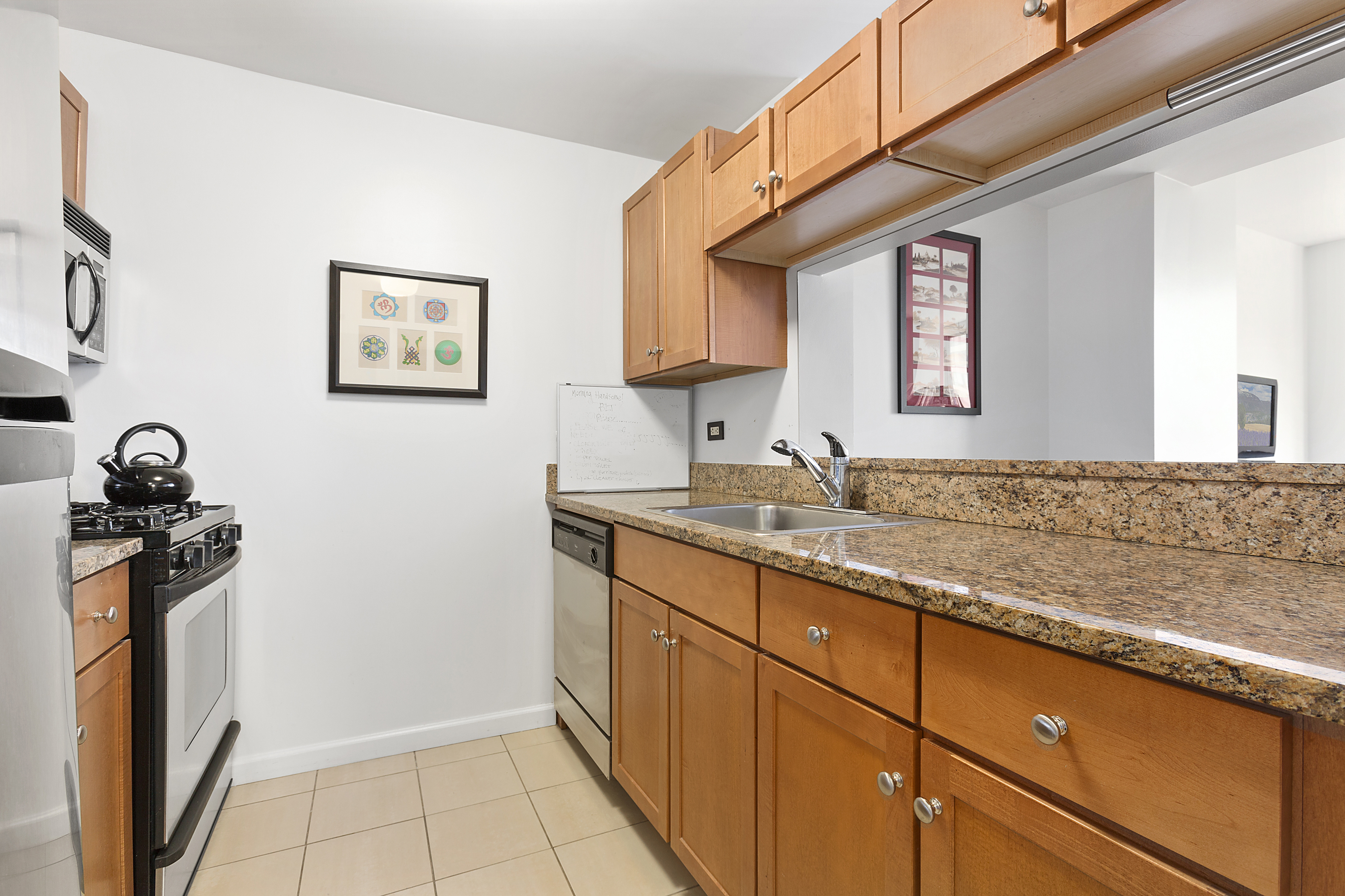 520 West 23rd Street, Unit 7E Manhattan, NY 10011 - Photo 3 of 9 a bathroom with a sink and a mirror