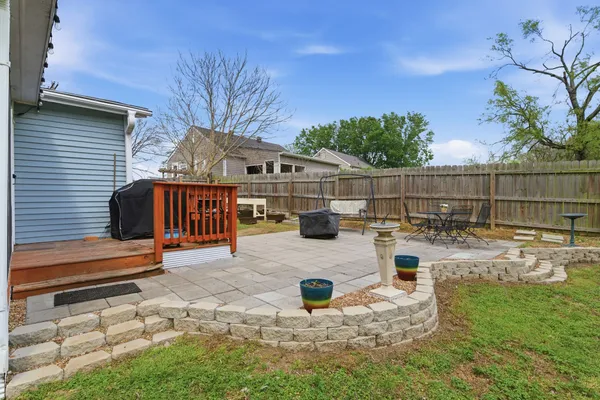 a view of backyard with swimming pool and seating space