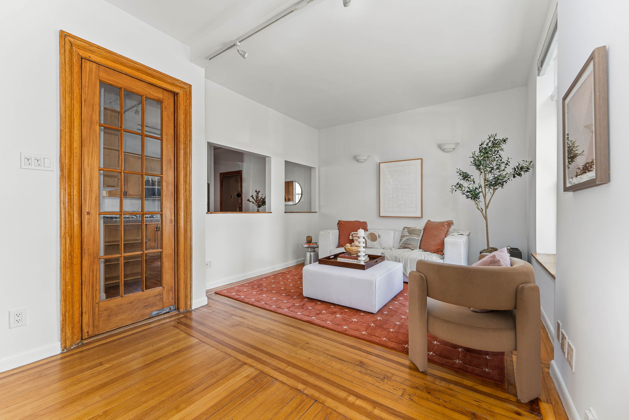826 43rd Street, Unit 1 Brooklyn, NY 11232 - Photo 2 of 12 a living room with furniture and a potted plant