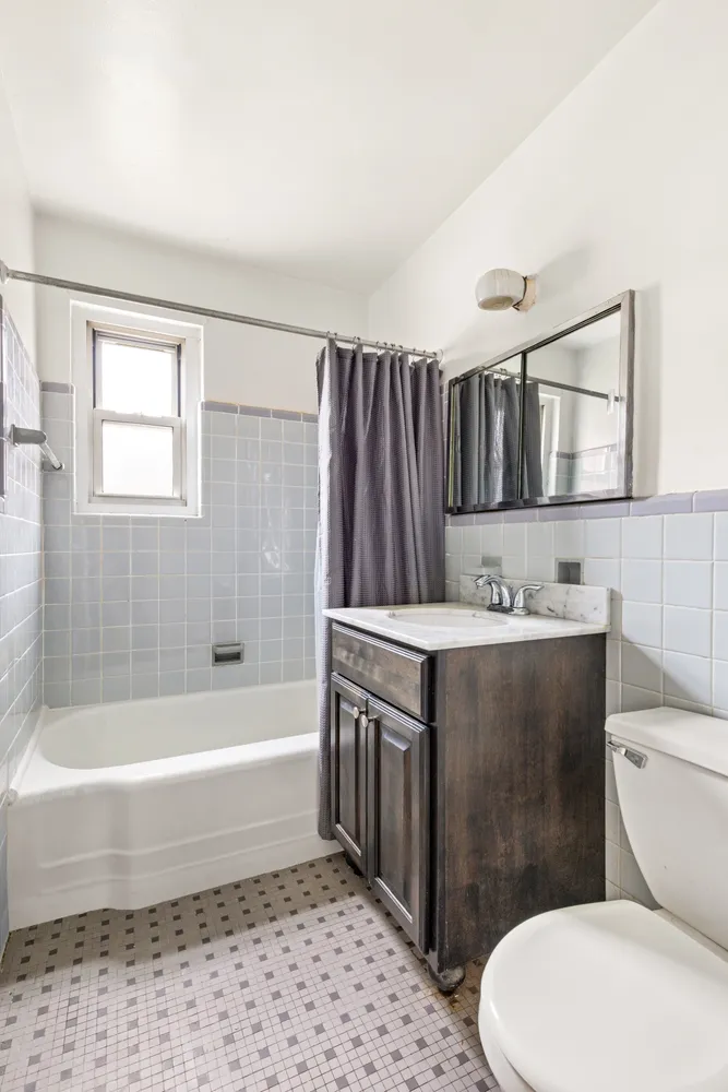 a bathroom with a sink a toilet and bathtub