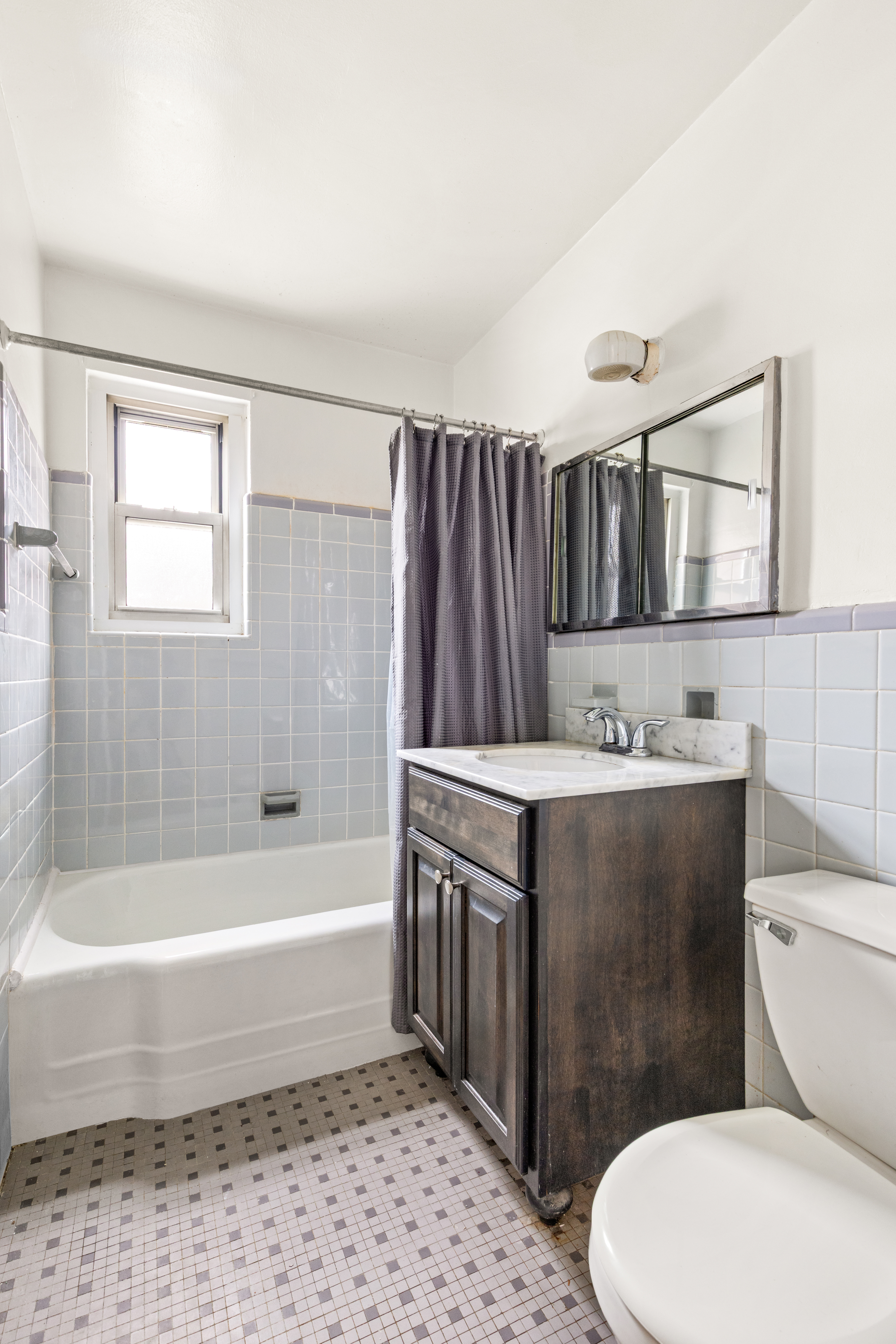 155-21 89th Street, Unit 2 Queens, NY 11414 - Photo 5 of 6 a bathroom with a sink a toilet and bathtub