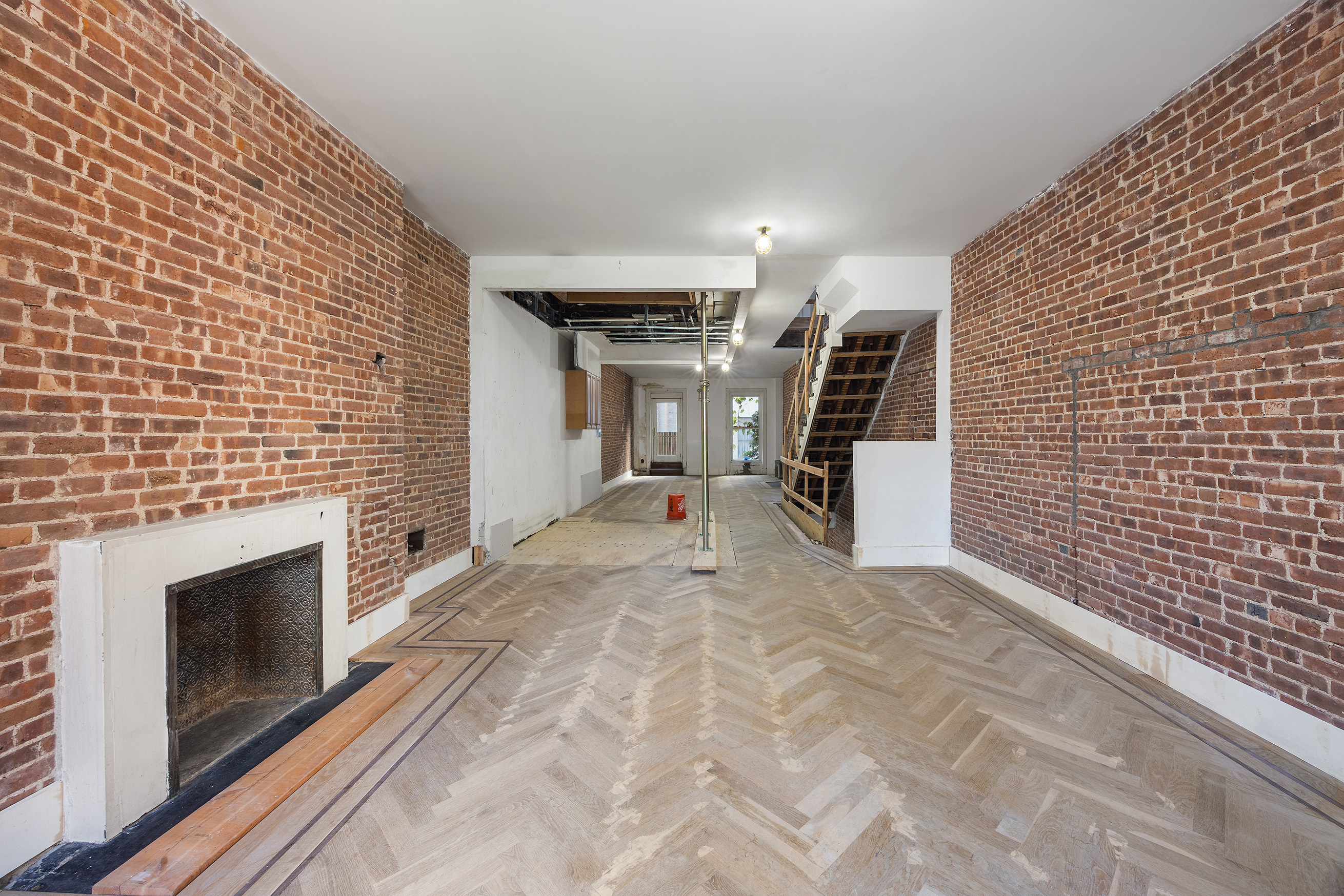 38 East 73rd Street Manhattan, NY 10021 - Photo 14 of 25 a view of a livingroom with stairs and a fireplace