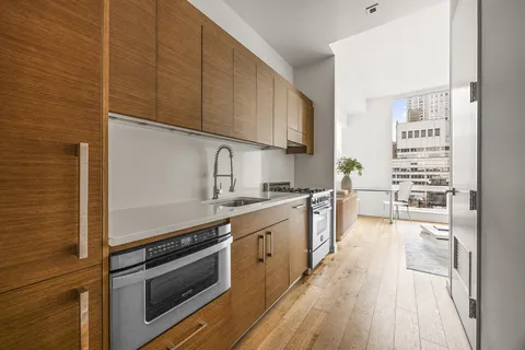 a kitchen with stainless steel appliances a stove sink and cabinets