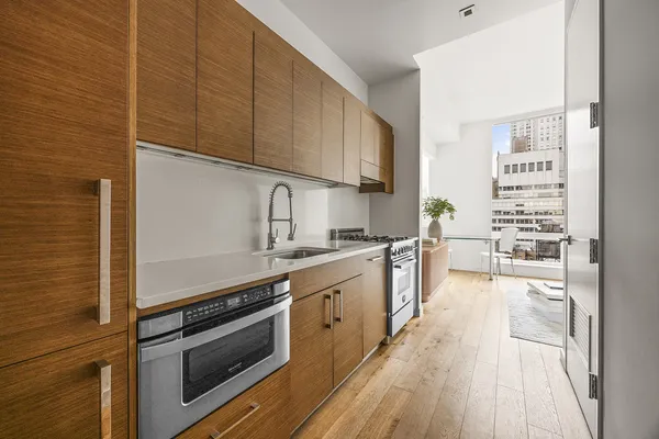 a kitchen with stainless steel appliances a stove sink and cabinets