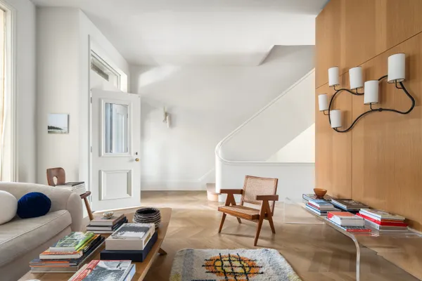 a living room with furniture and wooden floor
