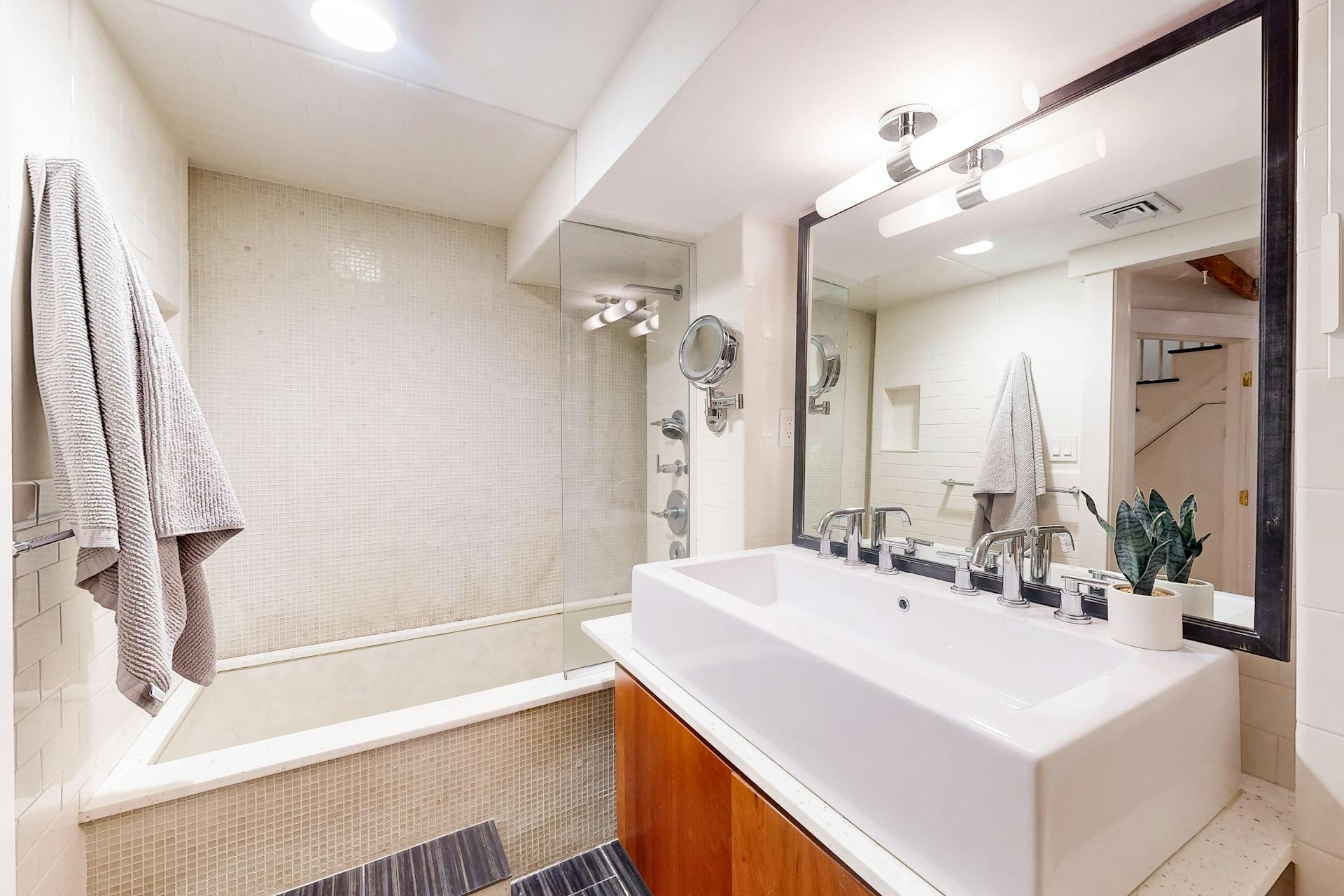 11 Fayette Street, Unit 1 Boston, MA 02116 - Photo 20 of 33 a bathroom with a sink a large mirror and shower