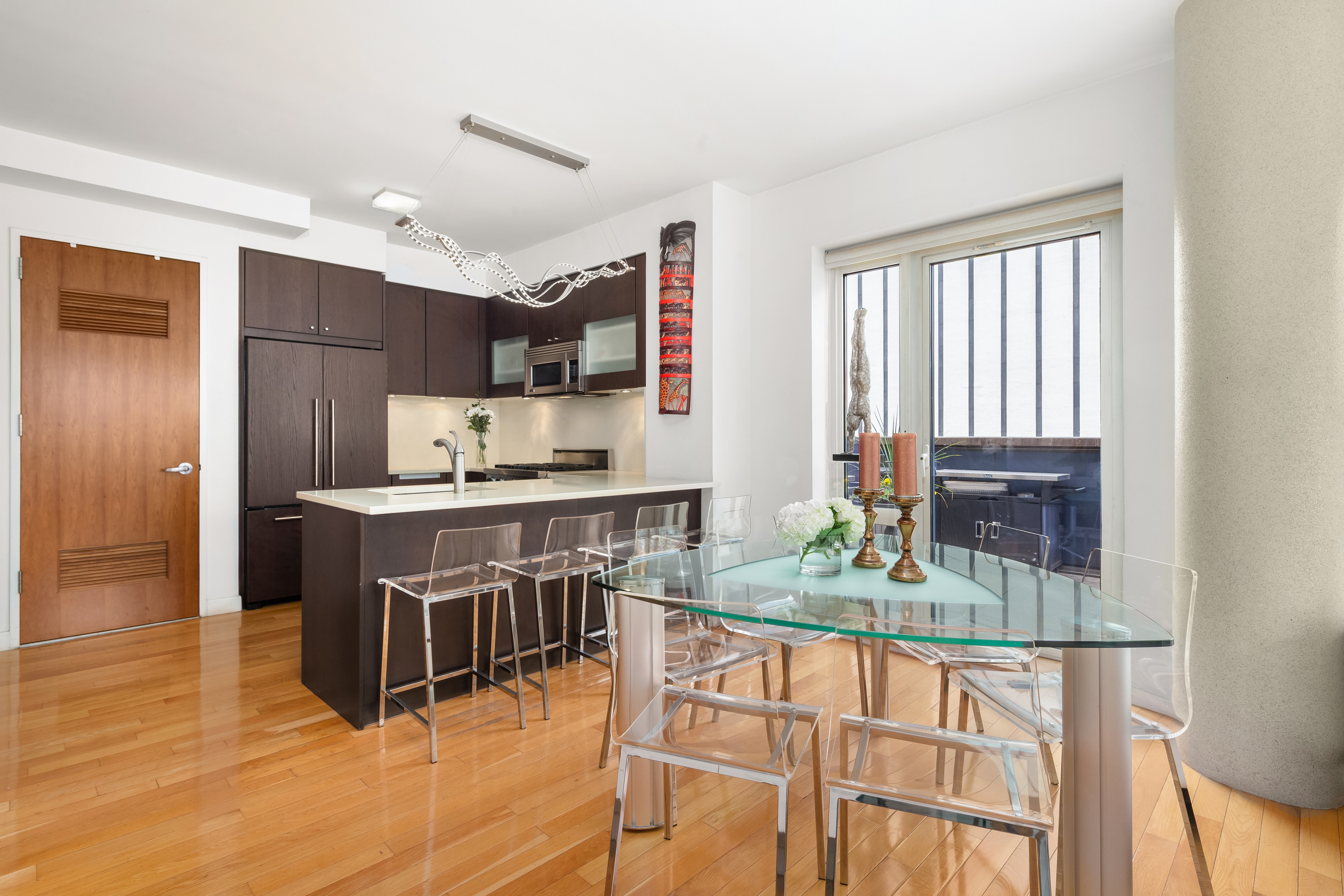 454 West 54th Street, Unit 7B Manhattan, NY 10019 - Photo 4 of 15 a kitchen with stainless steel appliances granite countertop a stove and a refrigerator