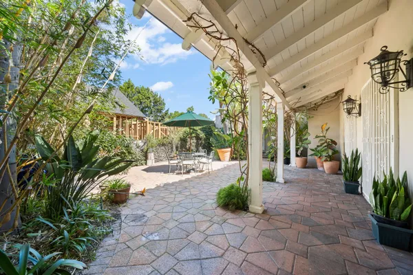 an aerial view of a house with a yard and outdoor seating
