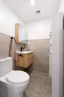 a bathroom with a sink a toilet and shower