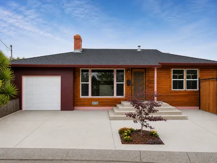 a front view of a house with outdoor seating