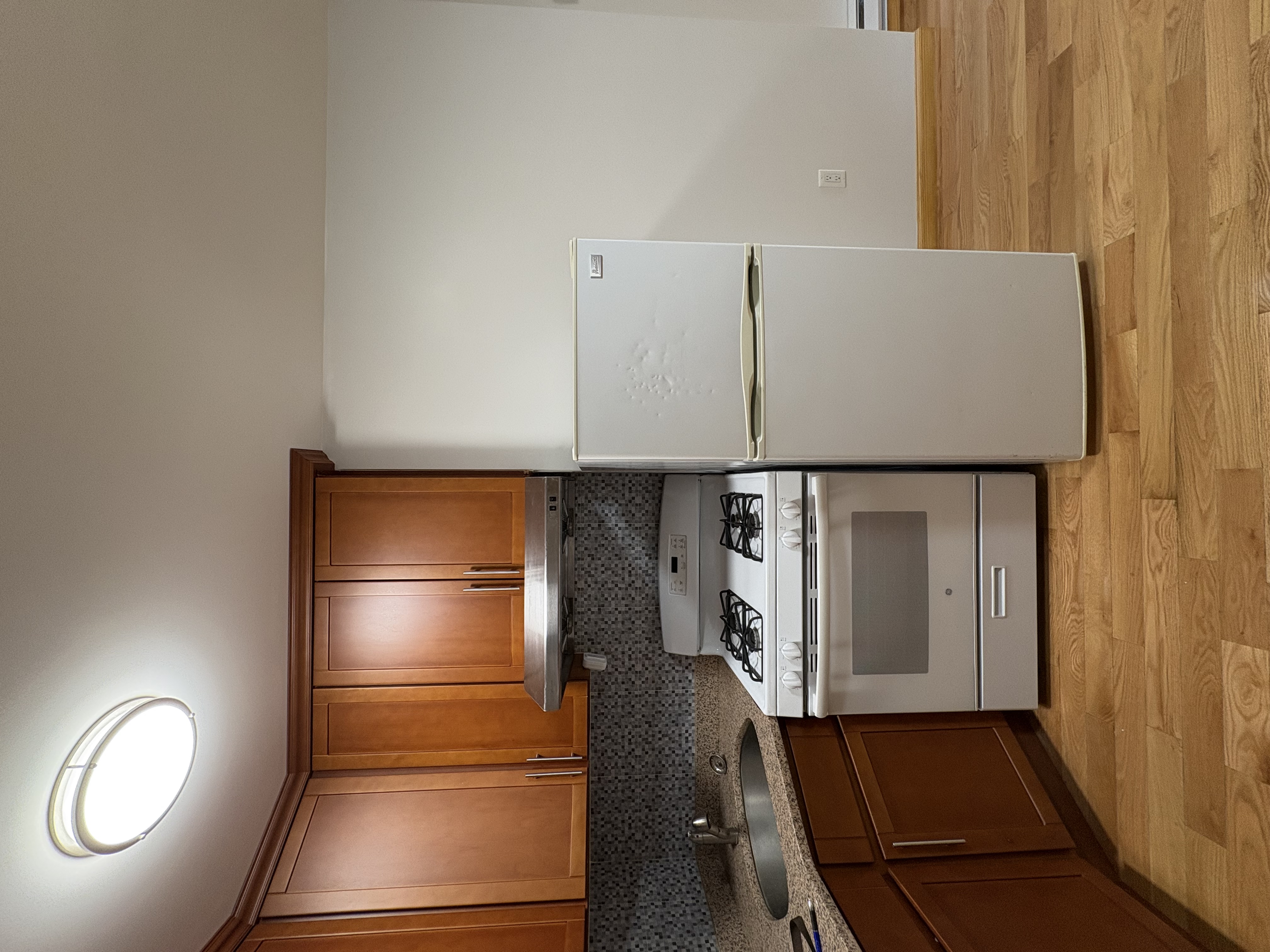 38 Ludlow Street, Unit 15 Manhattan, NY 10002 - Photo 11 of 16 a kitchen with a stove and a refrigerator