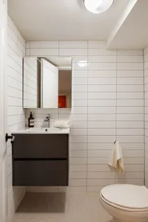 a bathroom with a sink mirror vanity and toilet