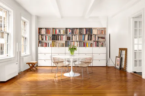 a living room with fireplace furniture and a book shelf