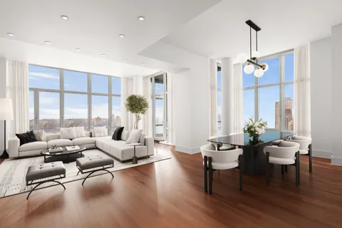 a living room with furniture floor to ceiling window and wooden floor